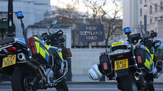 Two police motorbikes parked up outside New Scotland Yard