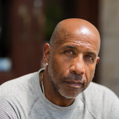A middle-aged man looks directly at the camera.
