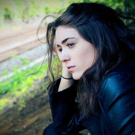A woman contemplatively looking out